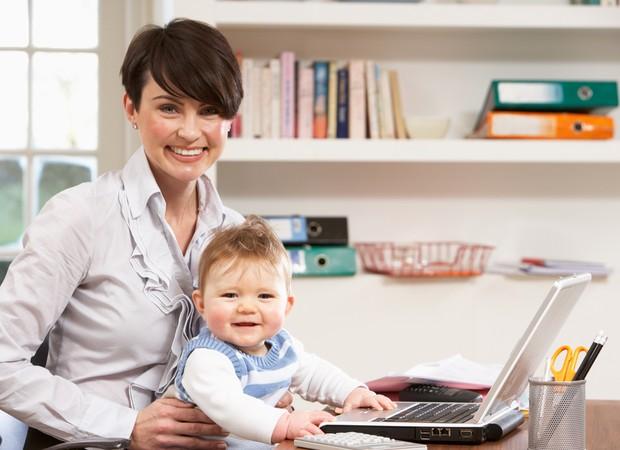 Mãe trabalhando em casa com o bebê ()