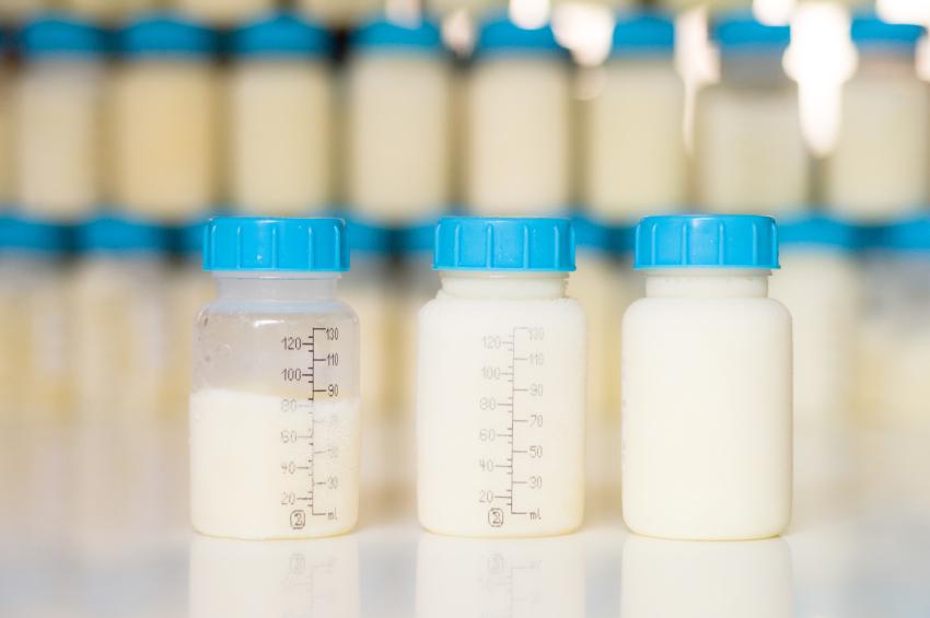 Breastfeeding and storage: Frozen mother milk with ice around the bottle freshly taken out of the freezer.